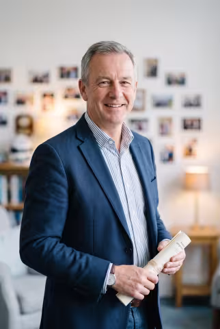 Alumni relations officer portrait, development office background — Person `person_portrait`.